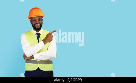 Check This. Black Male Construction Engineer Pointing Finger Aside At Copy Space Stock Photo