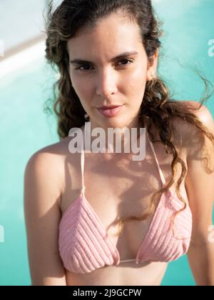 Young latin woman by the pool wearing crochet bikini Stock Photo - Alamy