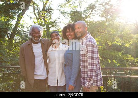 Happy multi-generation family standing in balcony Stock Photo
