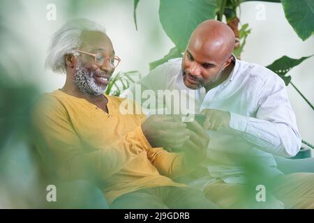 Father and son using smart phone Stock Photo
