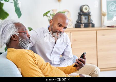 Father and son using smart phone Stock Photo