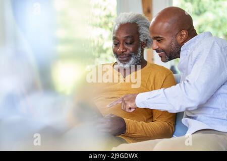 Father and son using smart phone Stock Photo