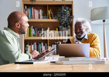 Smiling father and son using technologies Stock Photo