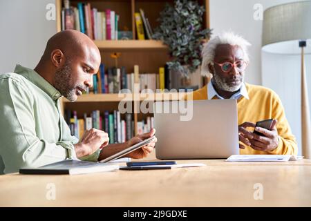 Father and son using technologies Stock Photo