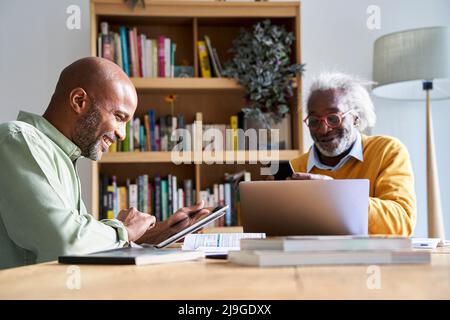Father and son using technologies Stock Photo