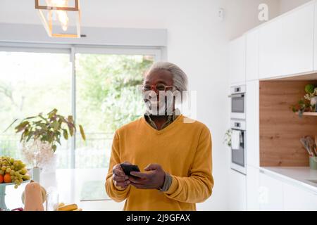 Senior man holding smart phone Stock Photo