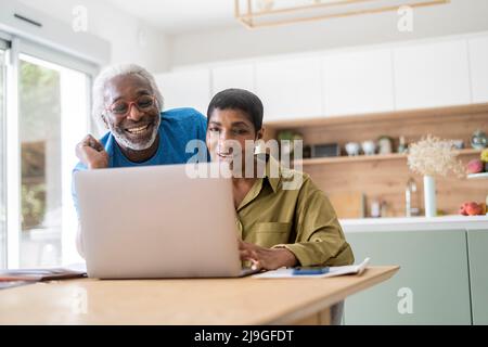 Couple checking documents in kitchen Stock Photo