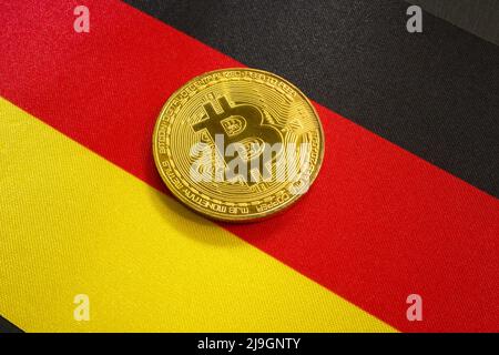 Bitcoin coin on the flag of Germany as a symbol of the law on cryptocurrencies. Stock Photo