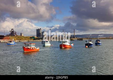 Landscape image showing fishing boats and industry at South Gare on Teesside near Middlesbrough, North Yorkshire, England, UK. Stock Photo