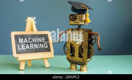 Machine learning concept. The robot is standing next to the chalkboard. Stock Photo