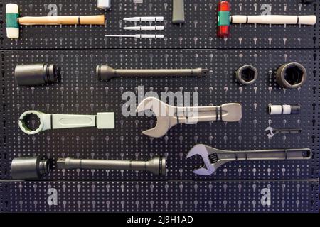 Various hand tools on a black bench Stock Photo