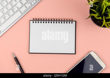 Flat lay office desk with note pad and computer keyboard Stock Photo