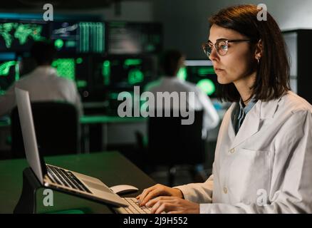 Female scientific research working on laptop computer in laboratory Stock Photo