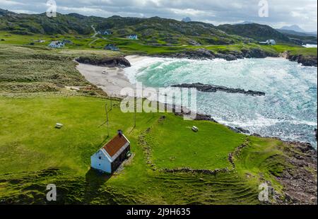 Aerial view from drone of beach and salmon fishing bothy at Clachtoll in Assynt, Sutherland, Highland, Scotland Stock Photo