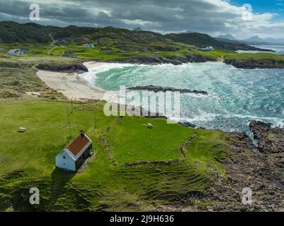 Aerial view from drone of beach and salmon fishing bothy at Clachtoll in Assynt, Sutherland, Highland, Scotland Stock Photo