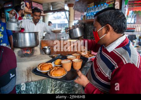 New Delhi, India. 18th Feb, 2022. Local waiter prepares serving tea for people at Sharma tea stall in Hazratganj. Tea is an integral part of everyday life in India. (Photo by Pradeep Gaur/SOPA Images/Sipa USA) Credit: Sipa USA/Alamy Live News Stock Photo