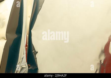 Silver foil shiny metal texture background. Folded crumpled metal background with colorful reflection Stock Photo