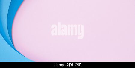 Abstract color papers geometry flat lay composition background with blue color curved lines and shapes on pastel pink background Stock Photo