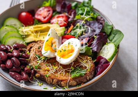 Medium boiled eggs with sasld, healthy breakfast Stock Photo