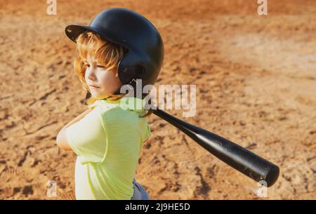 Child baseball player focused ready to bat. Kid holding a baseball bat. Stock Photo