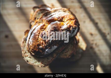 Sunlight falling on freshly baked bread slices on table Stock Photo
