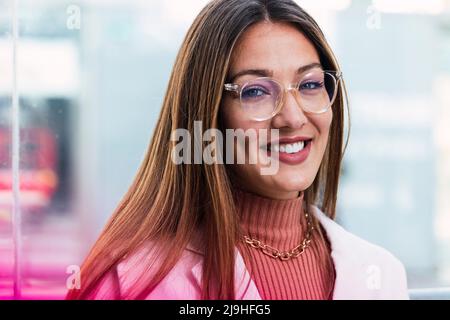 Smiling young woman wearing eyeglasses Stock Photo