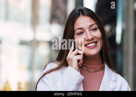 Happy woman talking on mobile phone Stock Photo