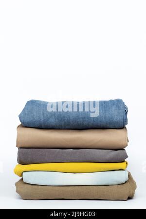 Stack of folded clothes on a white background. Stock Photo