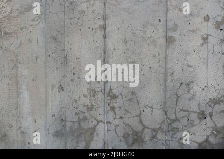 Reinforced concrete texture with areas covered with small cracks and spots. Surface of old and dirty reinforced concrete with traces of formwork. Stock Photo