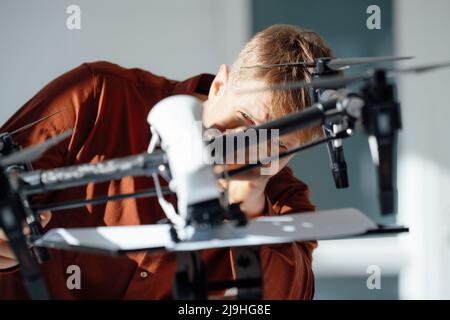 Engineer working on drone in office Stock Photo - Alamy