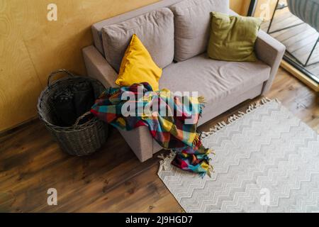 Colorful blanket on empty sofa Stock Photo
