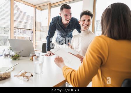 Happy young business people during a meeting in office Stock Photo