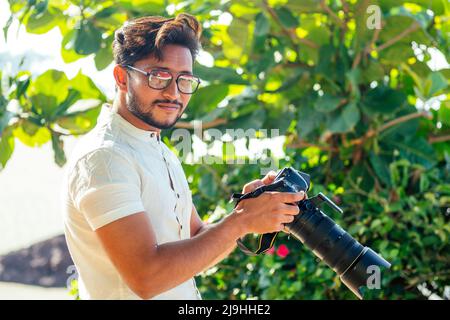 Man photographer with a DSLR camera in her hands posing in the forest Stock  Photo - Alamy