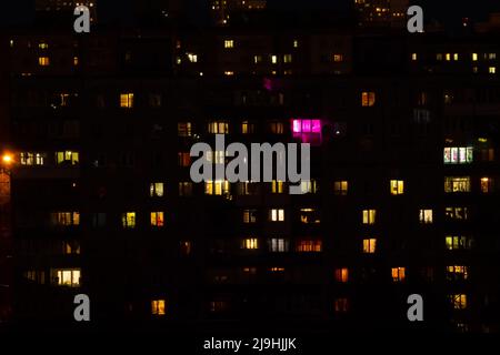 Living apartment building windows at night - facade view Stock Photo