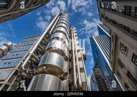 Looking up at the Lloyds of London Building in the heart of Londons financial district under a blue sky in May 2022. Stock Photo