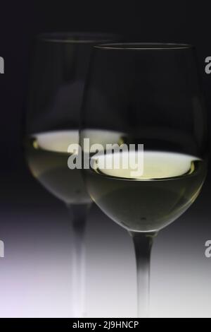 Glasses of white wine against black background Stock Photo