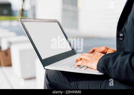 Hands of businesswoman typing on laptop Stock Photo