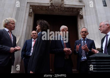 London, UK. 23 May, 2022.  Members of Fossil Free London (FFL) and Extinction Rebellion (XR) staged a protest impersonating Shell executives walking on a code red carpet in the eve of the company’s annual general meeting (AGM). Despite claiming to “strongly support” the Paris Agreement, Shell is actively appealing a landmark court ruling in the Netherlands that states Shell must reduce its carbon emissions and is already failing to comply with the verdict. Meanwhile, the company has moved its headquarters to the UK and is continuing with plans to invest billions in further oil and gas extracti Stock Photo