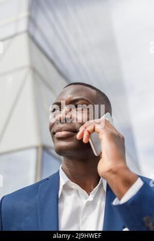 Smiling businessman talking on mobile phone Stock Photo