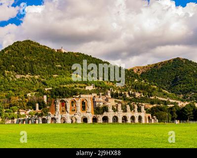 Gubbio, ancient ruins of the roman amphitheater with the medieval village in background, Umbria region, central Italy Stock Photo