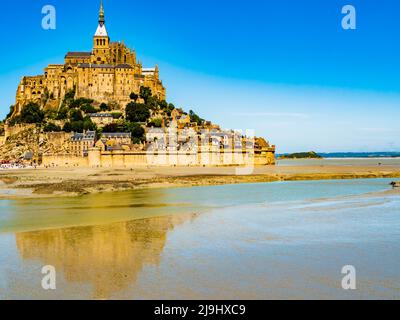 Le Mont Saint Michel, impressive view of the famous abbey during low tide on a bright sunny day, Normandy, Northern France