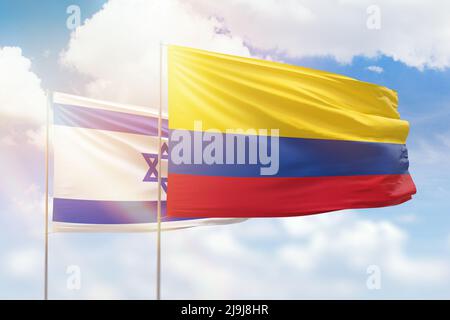 Sunny blue sky and flags of colombia and israel Stock Photo