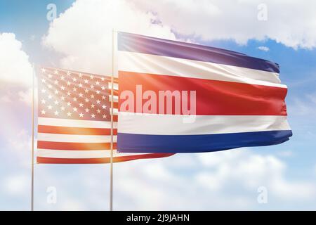 Sunny blue sky and flags of costa rica and usa Stock Photo