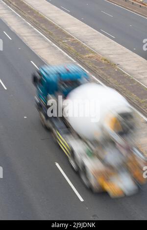 A blurred image from above and behind of a concrete mixer truck (no brand names) speeding on a motorway in Sydney, Australia Stock Photo