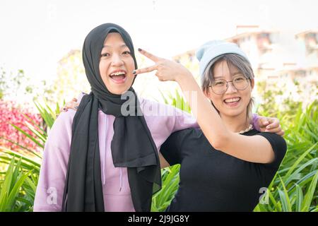 Two young happy women friends having fun, looking at camera. Friendship and best friends forever concept. Stock Photo