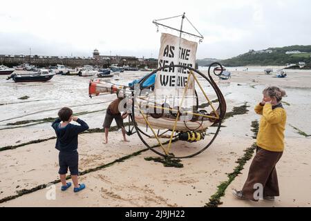 St Ives, UK. 11th June, 2021. Extinction Rebellion protesters put their fingers in their ears during a 'Sound the Alarm' for climate change protest. The theme refers to the fact that a wealthy minority of the world's countries and economies are the main cause of the climate and ecological crisis which mainly impacts the poor who have contributed the least to the crisis. (Credit Image: © Joe M O'Brien/SOPA Images via ZUMA Press Wire) Stock Photo