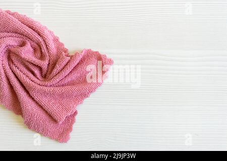 close up light pink microfiber texture. Cleaning rag fluffy cloth on the table. Household concept. Copy space Stock Photo