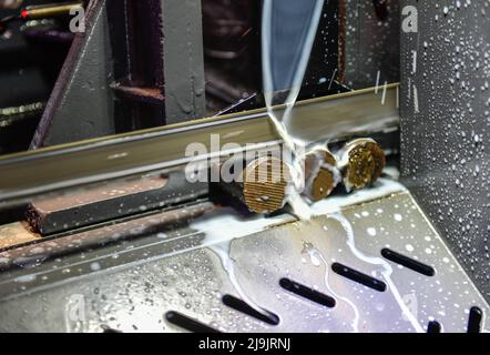 Industrial metal working cutting process The raw material bar clamping on the CNC lathe machine Stock Photo
