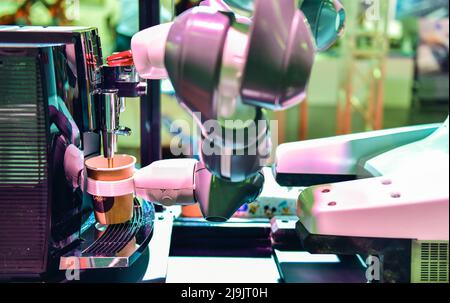 Automatic technology in beverage shop, artificial intelligence, robotic arm serving in coffee shop. Stock Photo