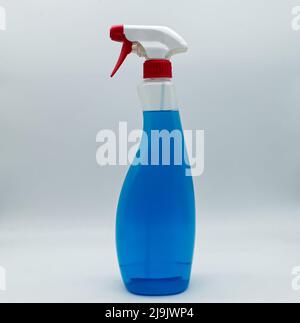 Transparent plastic bottle with dispenser. Full container with blue liquid isolated on white background. Stock Photo
